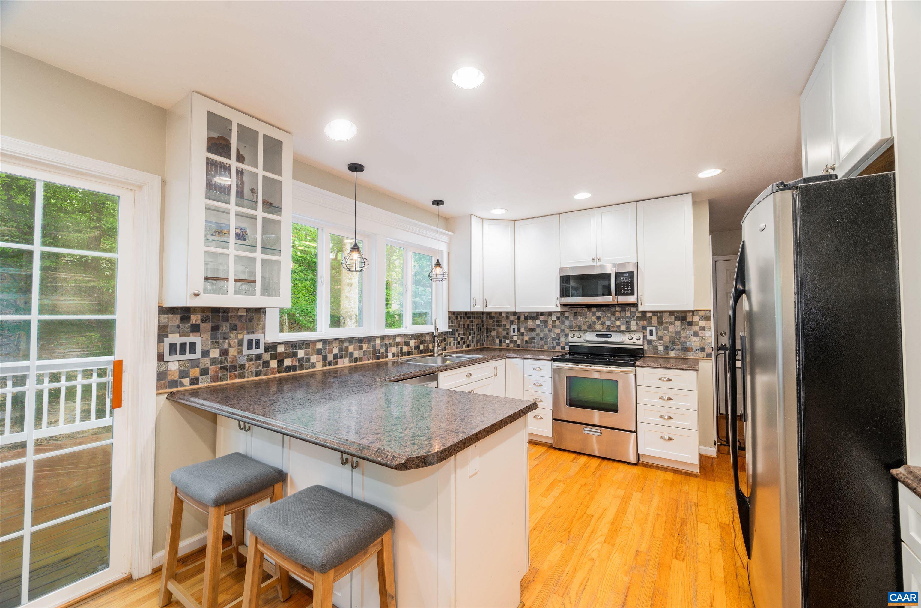 31 Zephyr Road Palmyra, VA 22963 - Photo 3 of 44 a kitchen with stainless steel appliances granite countertop a stove and a refrigerator
