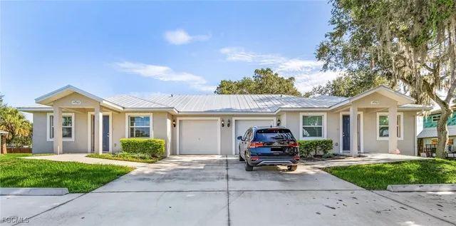 a view of a house with a cars park front of a house
