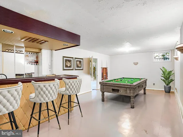 a room with chairs and wooden floor