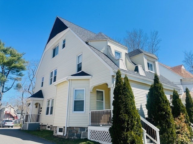 32 Newcomb Place, Unit 2 Taunton, MA 02780 - Photo 2 of 8 a view of a white house with many windows and plants