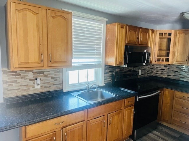 32 Newcomb Place, Unit 2 Taunton, MA 02780 - Photo 3 of 8 a kitchen with granite countertop a sink dishwasher stove and cabinets