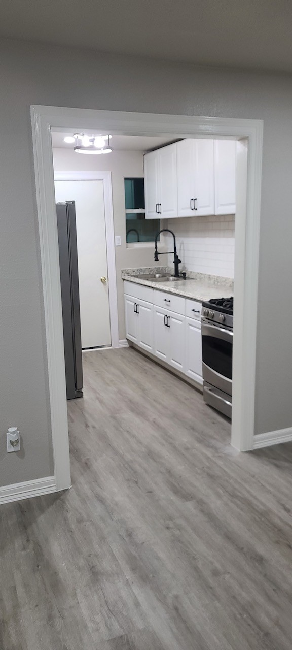 791 Fortune Street, Unit 4 Houston, TX 77088 - Photo 2 of 8 a kitchen with stainless steel appliances a stove a sink and a refrigerator