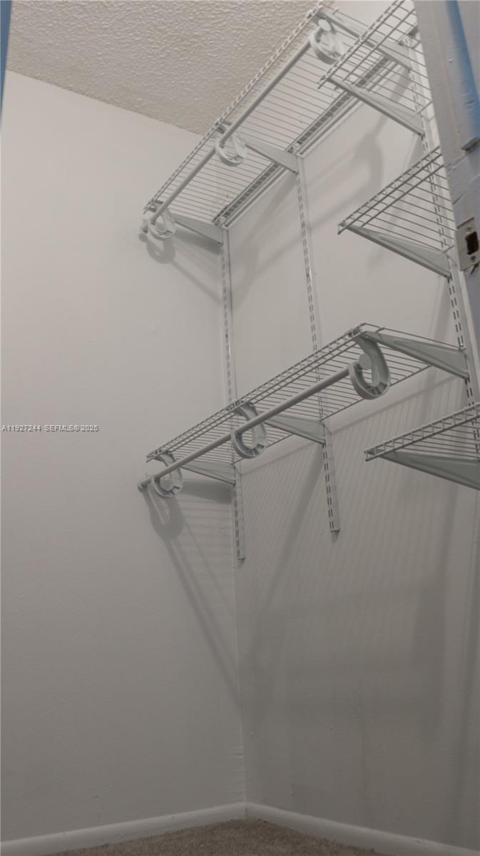 9421 Evergreen Place, Unit 103 Davie, FL 33324 - Photo 16 of 32 a view of a room with racks on the wall