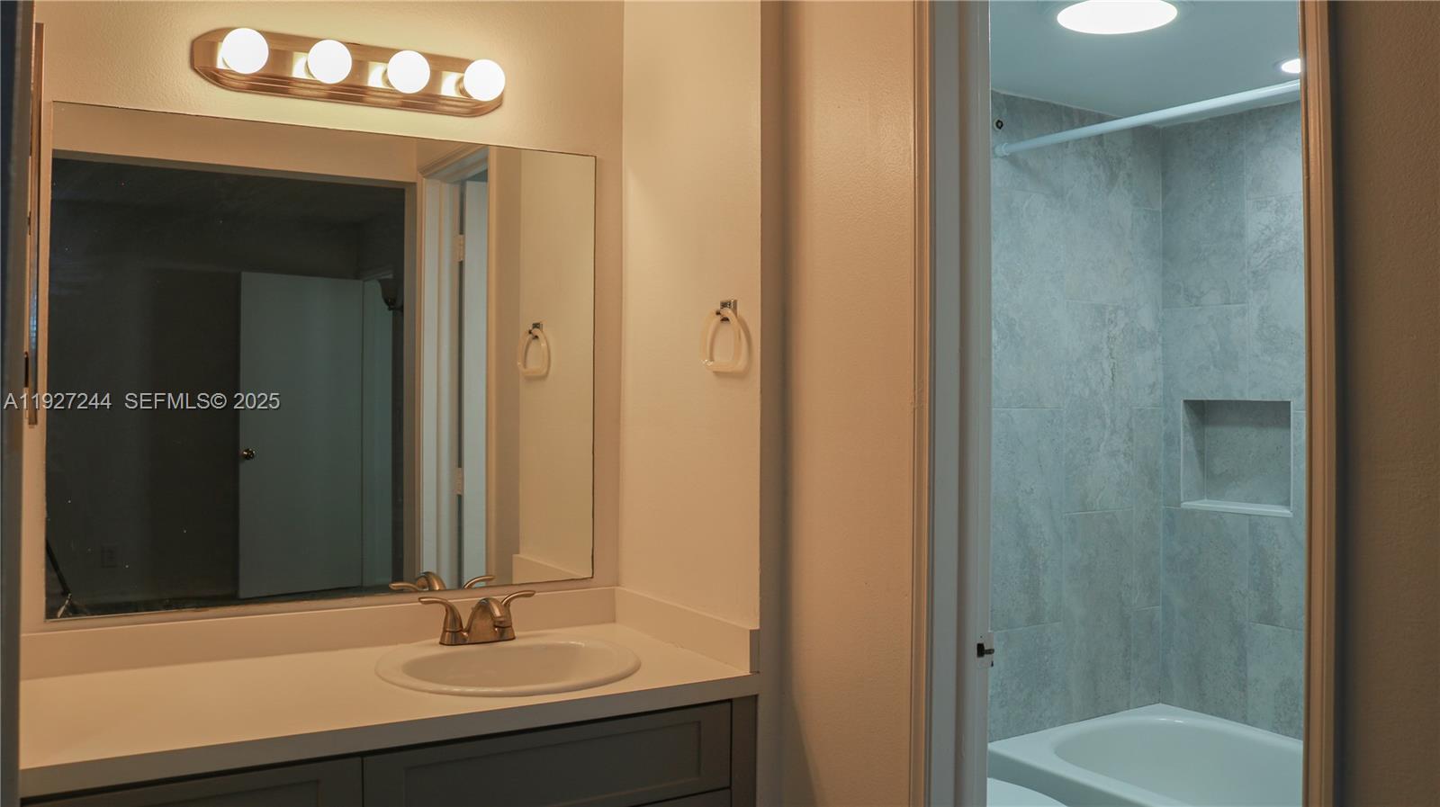 9421 Evergreen Place, Unit 103 Davie, FL 33324 - Photo 17 of 32 a bathroom with a sink a toilet and shower