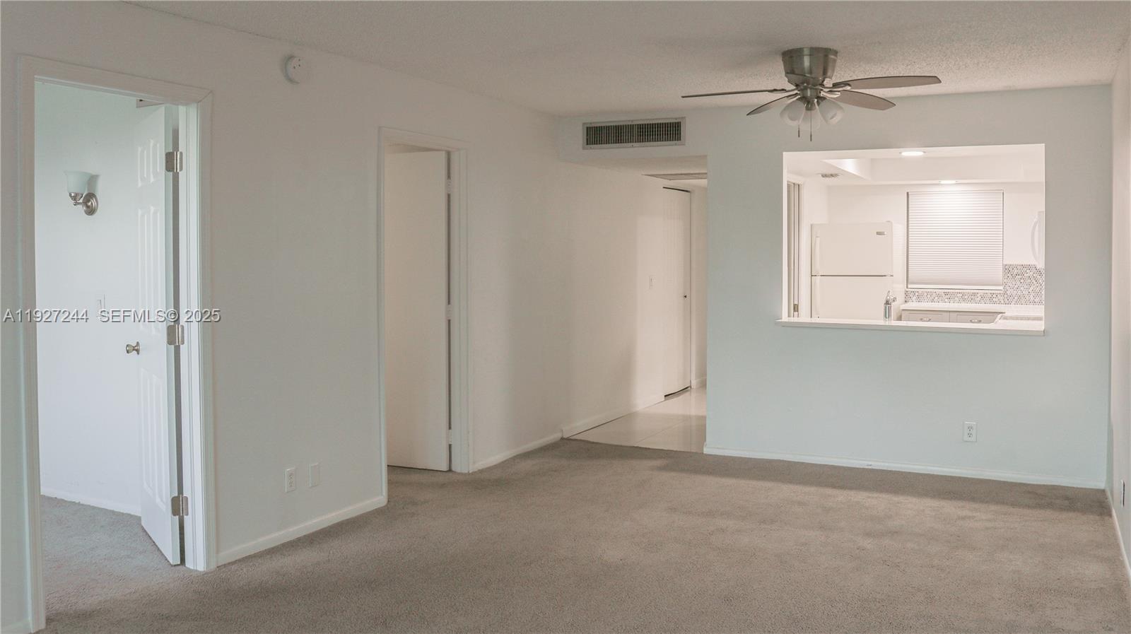 9421 Evergreen Place, Unit 103 Davie, FL 33324 - Photo 19 of 32 an empty room with a window and a ceiling fan