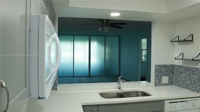 a bathroom with a sink and a large mirror