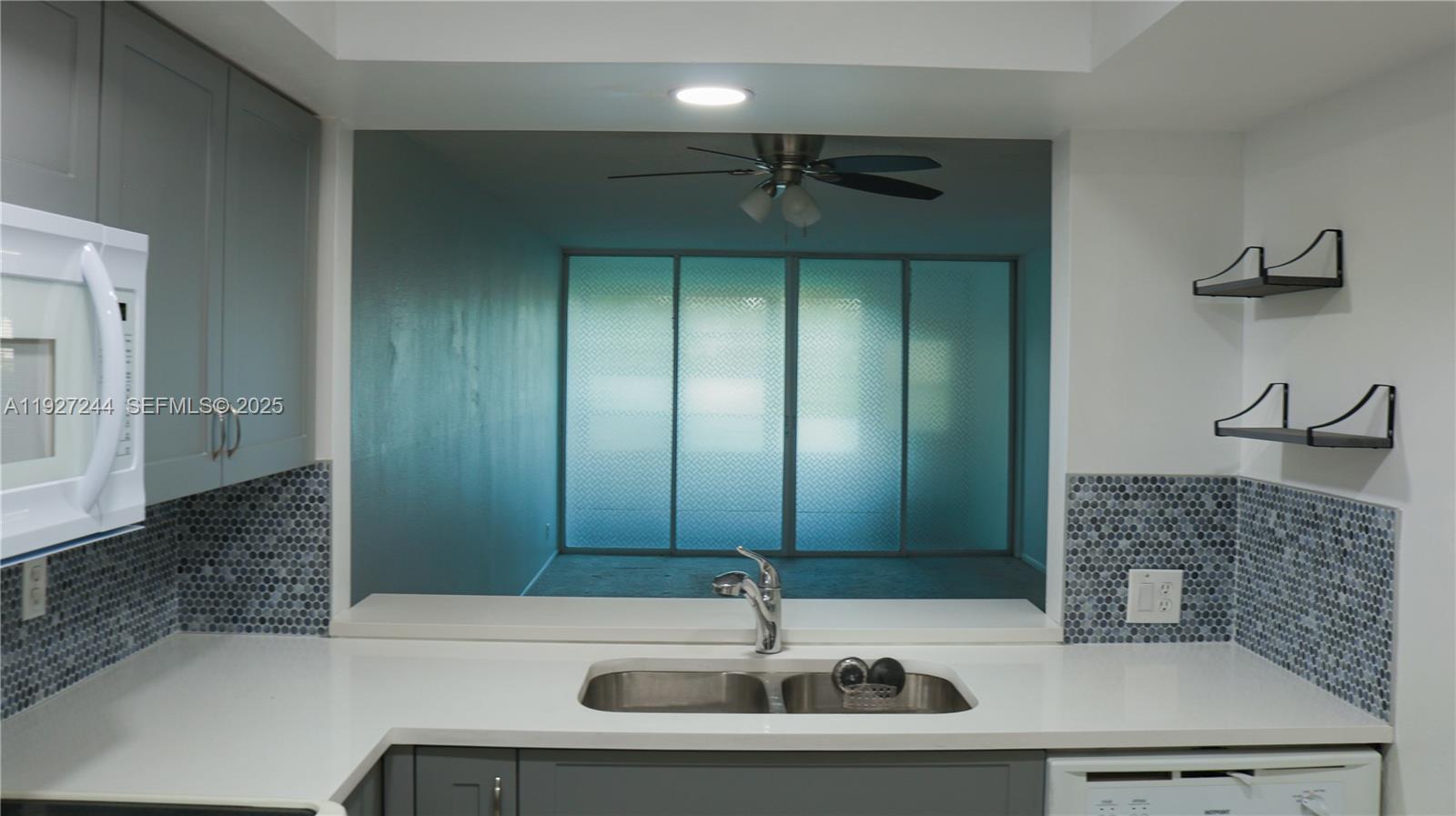 9421 Evergreen Place, Unit 103 Davie, FL 33324 - Photo 22 of 32 a bathroom with a sink and a mirror
