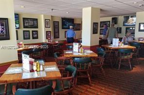 9421 Evergreen Place, Unit 103 Davie, FL 33324 - Photo 30 of 32 a view of a dining room with furniture and wooden floor
