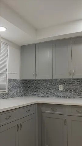 a view of kitchen with cabinets