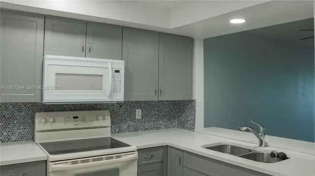 a kitchen with a sink and cabinets