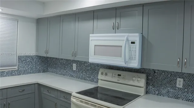a kitchen with a sink and a microwave