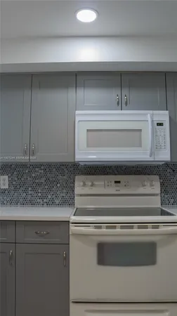 a stove top oven sitting inside of a kitchen