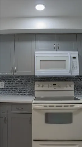 a stove top oven sitting inside of a kitchen