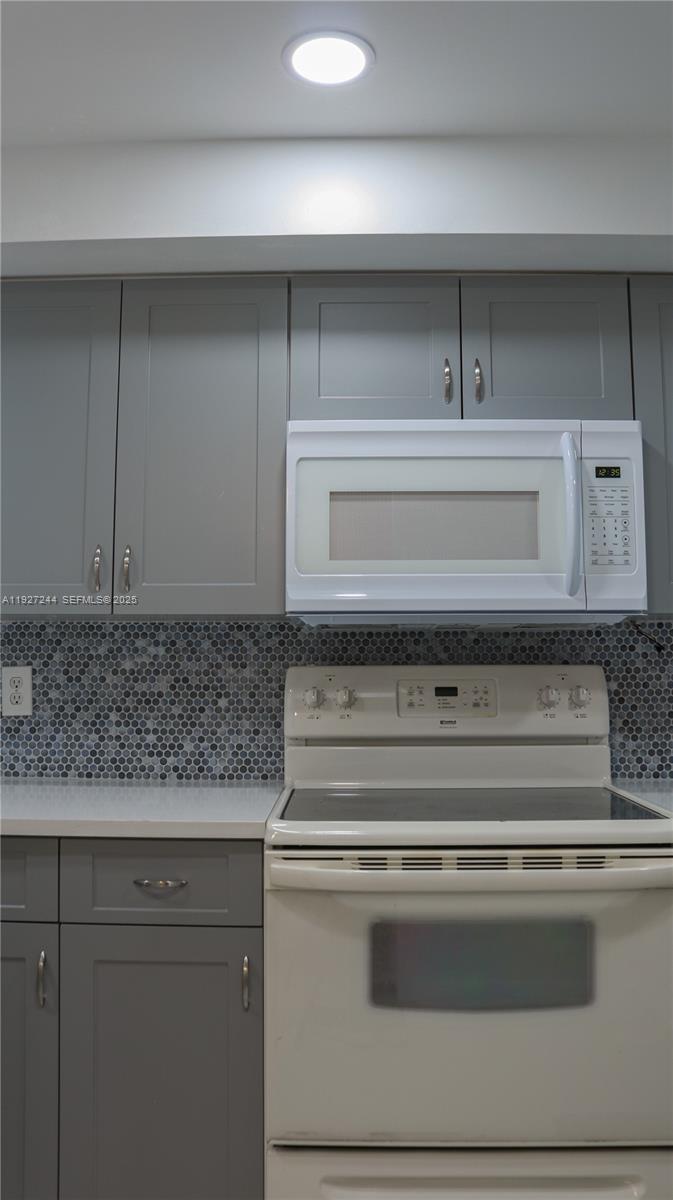 9421 Evergreen Place, Unit 103 Davie, FL 33324 - Photo 8 of 32 a stove top oven sitting inside of a kitchen