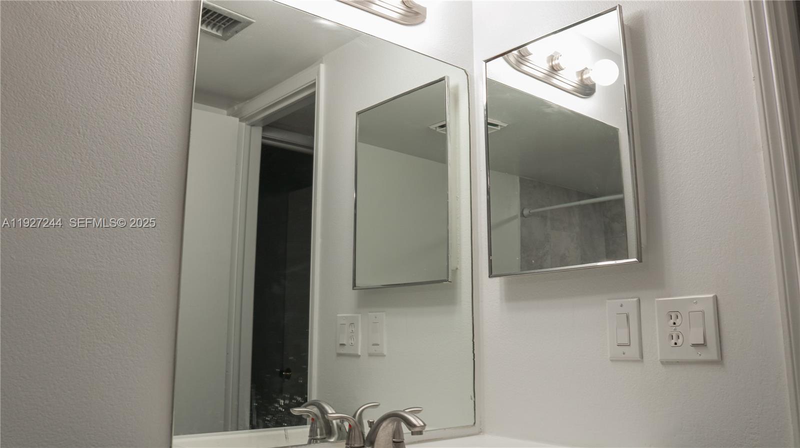 9421 Evergreen Place, Unit 103 Davie, FL 33324 - Photo 10 of 32 a bathroom with a mirror