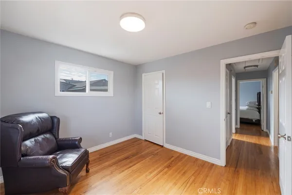 a bedroom with furniture and wooden floor