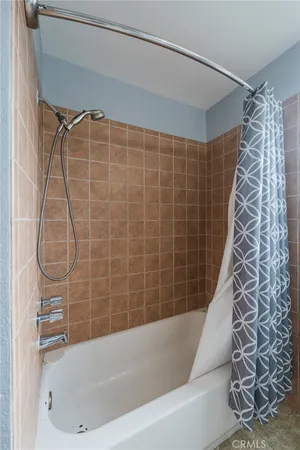 a bathroom with a bathtub and shower