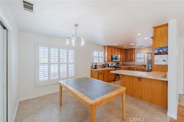 a kitchen with a stove a sink dishwasher and a refrigerator