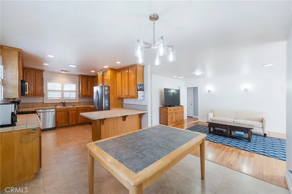 a large kitchen with a table and chairs