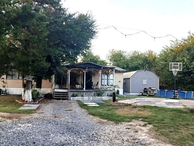 a view of a house with backyard and sitting area