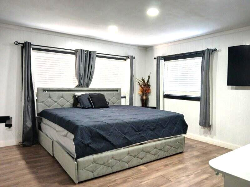 9153 Bouncer Road Quinlan, TX 75474 - Photo 11 of 27 a large bed sitting in a bedroom next to a window