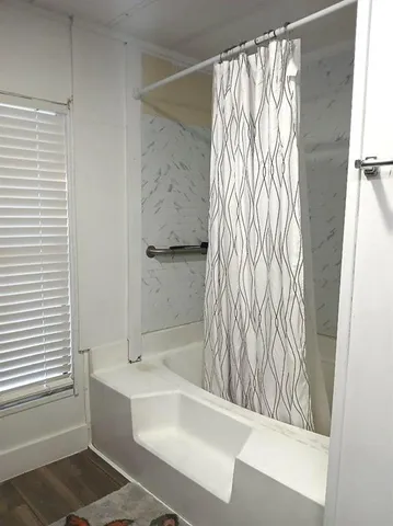 a bathroom with a bathtub and shower