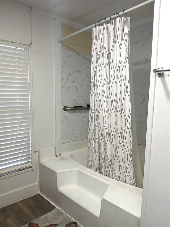 9153 Bouncer Road Quinlan, TX 75474 - Photo 13 of 27 a bathroom with a bathtub and shower