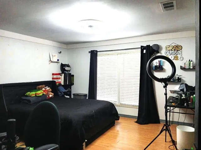 a bedroom with a bed closet and a window