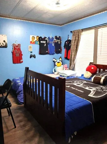 a bedroom with a bed and dresser