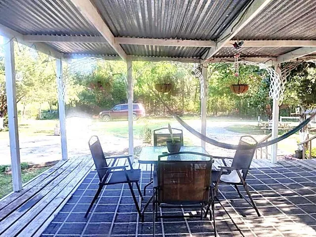 a backyard of a house with table and chairs