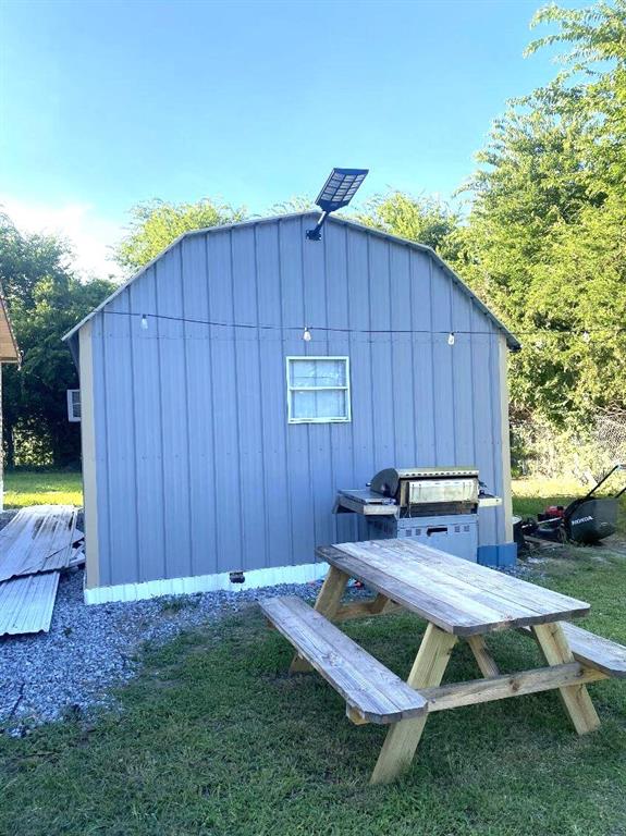9153 Bouncer Road Quinlan, TX 75474 - Photo 23 of 27 a view of a backyard with a tub and outdoor seating