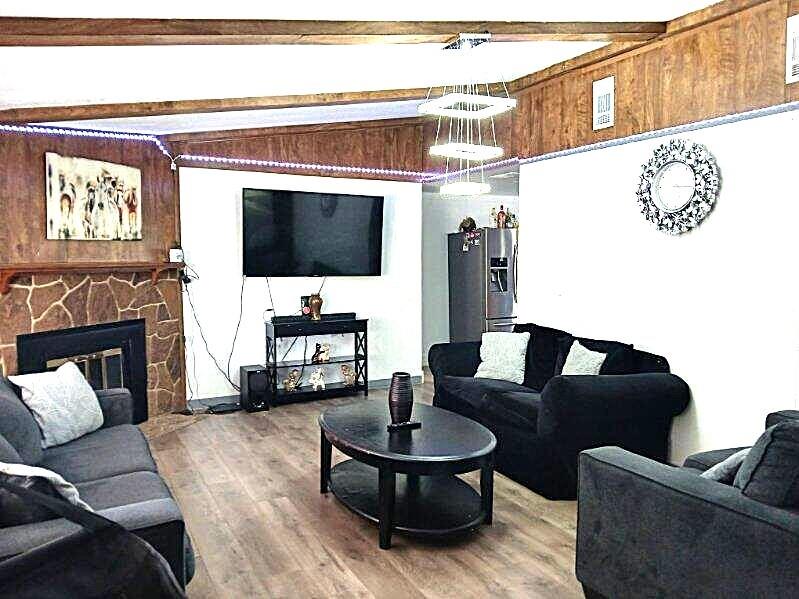 9153 Bouncer Road Quinlan, TX 75474 - Photo 4 of 27 a living room with furniture a fireplace and a flat screen tv