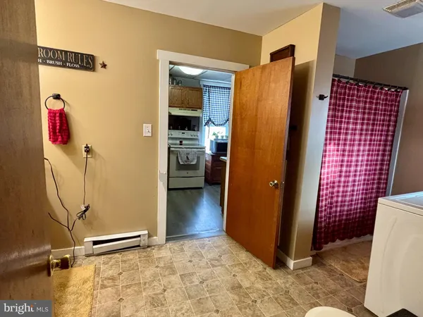 a bedroom with a bed table closet and flat screen tv
