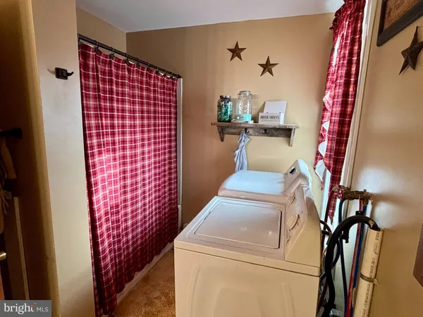 a large kitchen with stainless steel appliances granite countertop a refrigerator and a stove top oven