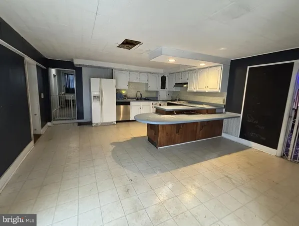 a kitchen with a refrigerator and a sink