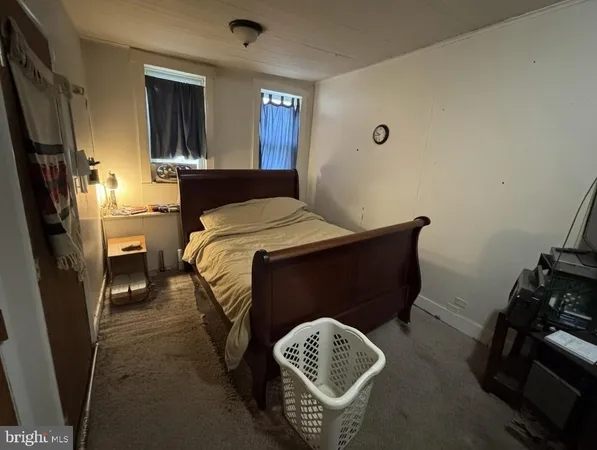 a living room with furniture a flat screen tv and gym equipment