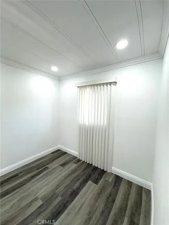 an empty room with wooden floor