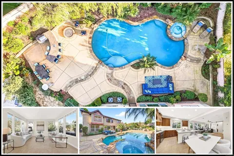an aerial view of a house with a swimming pool and outdoor seating