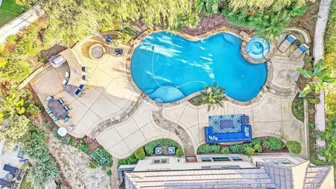 a view of a house with backyard and sitting area