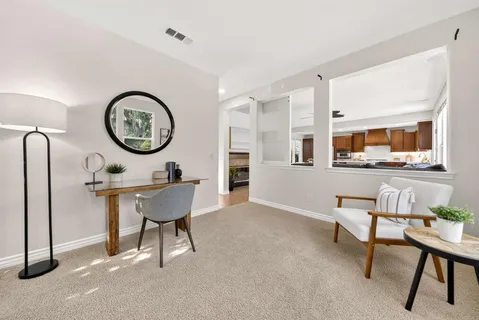a living room with furniture and a chandelier