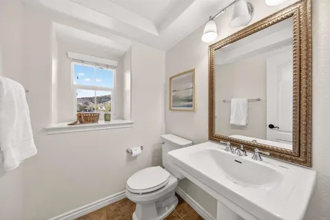 a spacious bathroom with a granite countertop double vanity sink a mirror and a