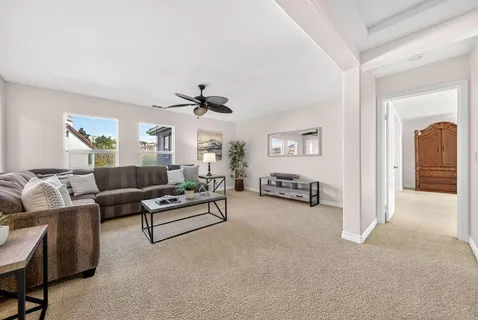 a living room with furniture and a chandelier