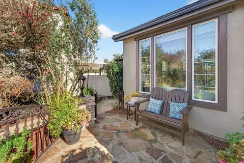 a dining room with chandelier and wooden floor