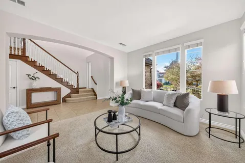 a living room with furniture and a potted plant