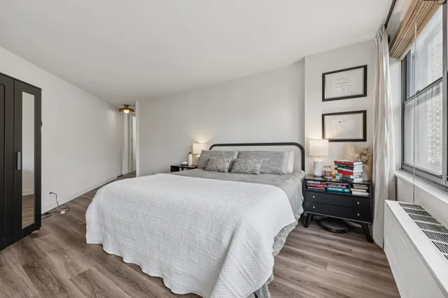 a bedroom with a bed and a large mirror