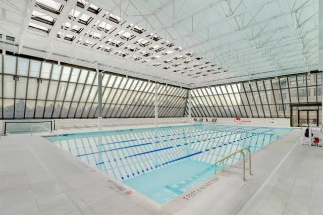 an aerial view of a tennis ground and a houses