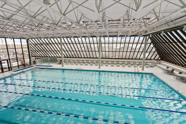 a view of a swimming pool with outdoor seating