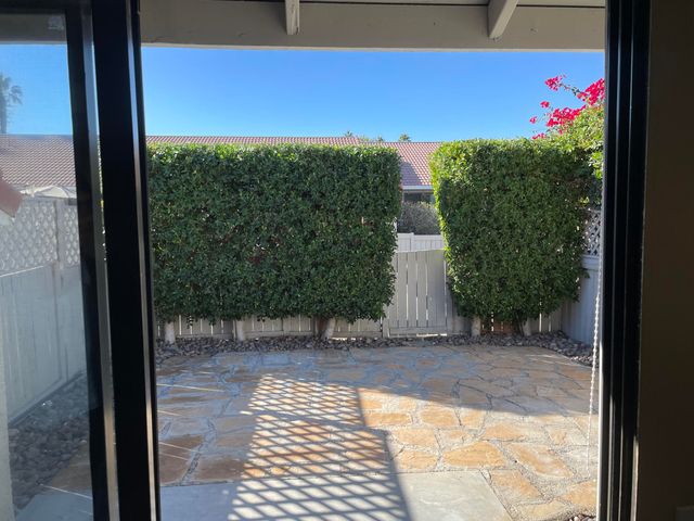 a view of a house with swimming pool and sitting area
