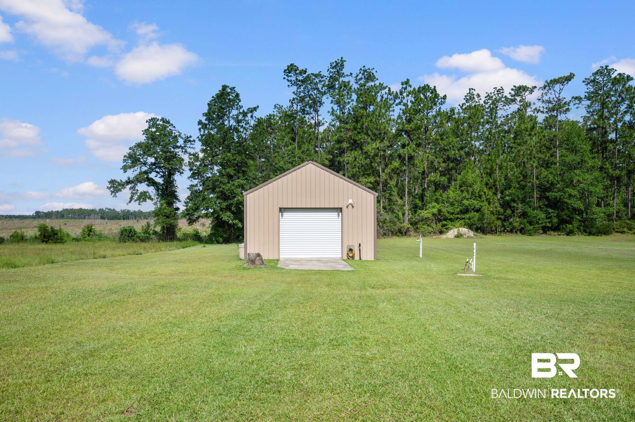 48513 Phillipsville Road Bay Minette, AL 36507 - Photo 48 of 50 View of grassy yard with a detached garage and an outbuilding