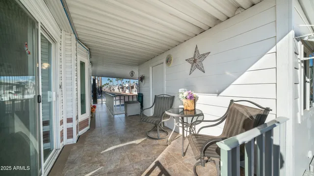 a living room with furniture a chandelier and a flat screen tv